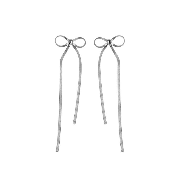 Close-up of two silver Orecchini Fiocco Luminoso. Bow-shaped earrings with thin, dangling strands. Elegant jewelry.